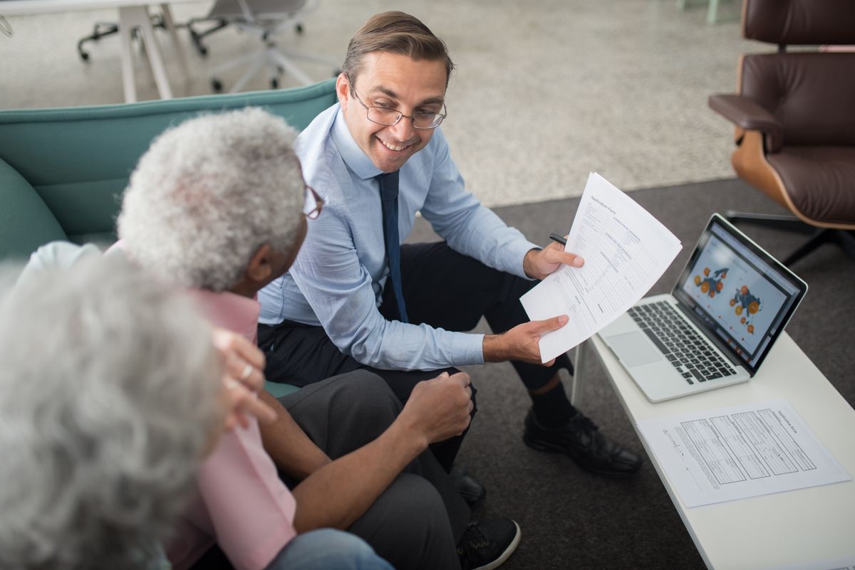A licensed Coastline agent reviewing an auto insurance policy with a client