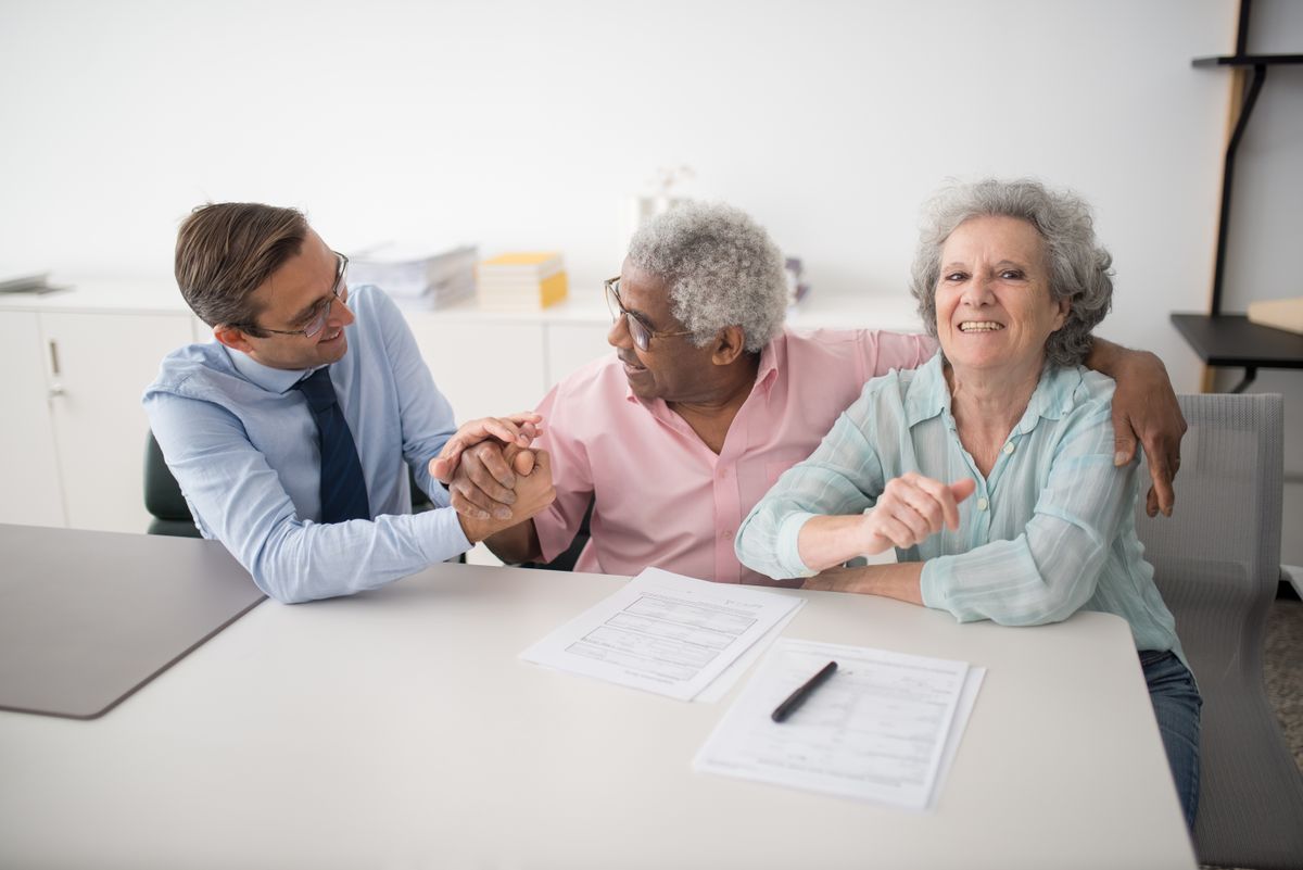 Two happy clients meeting with their Coastline insurance agent