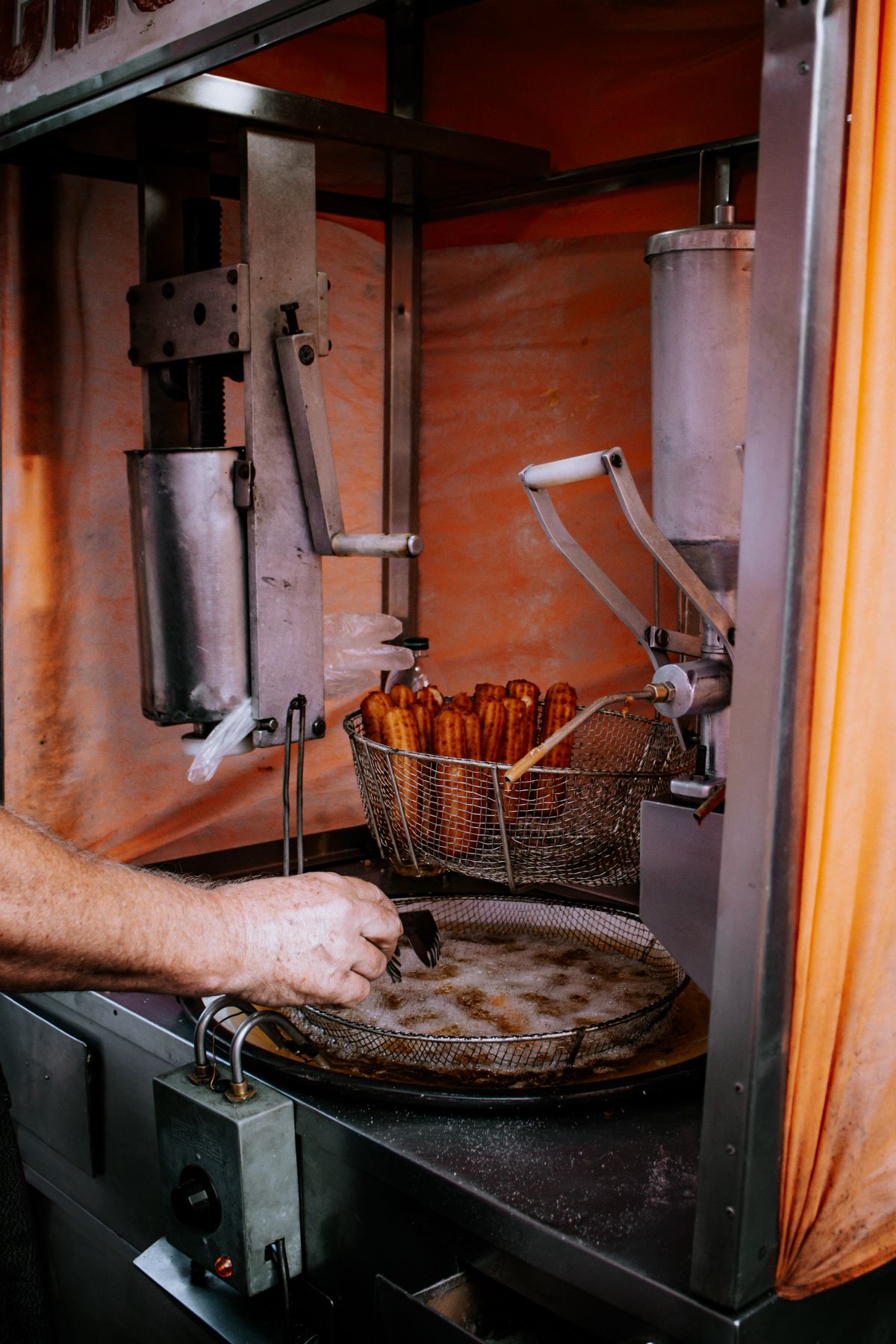 Fresh churros being fried and prepared