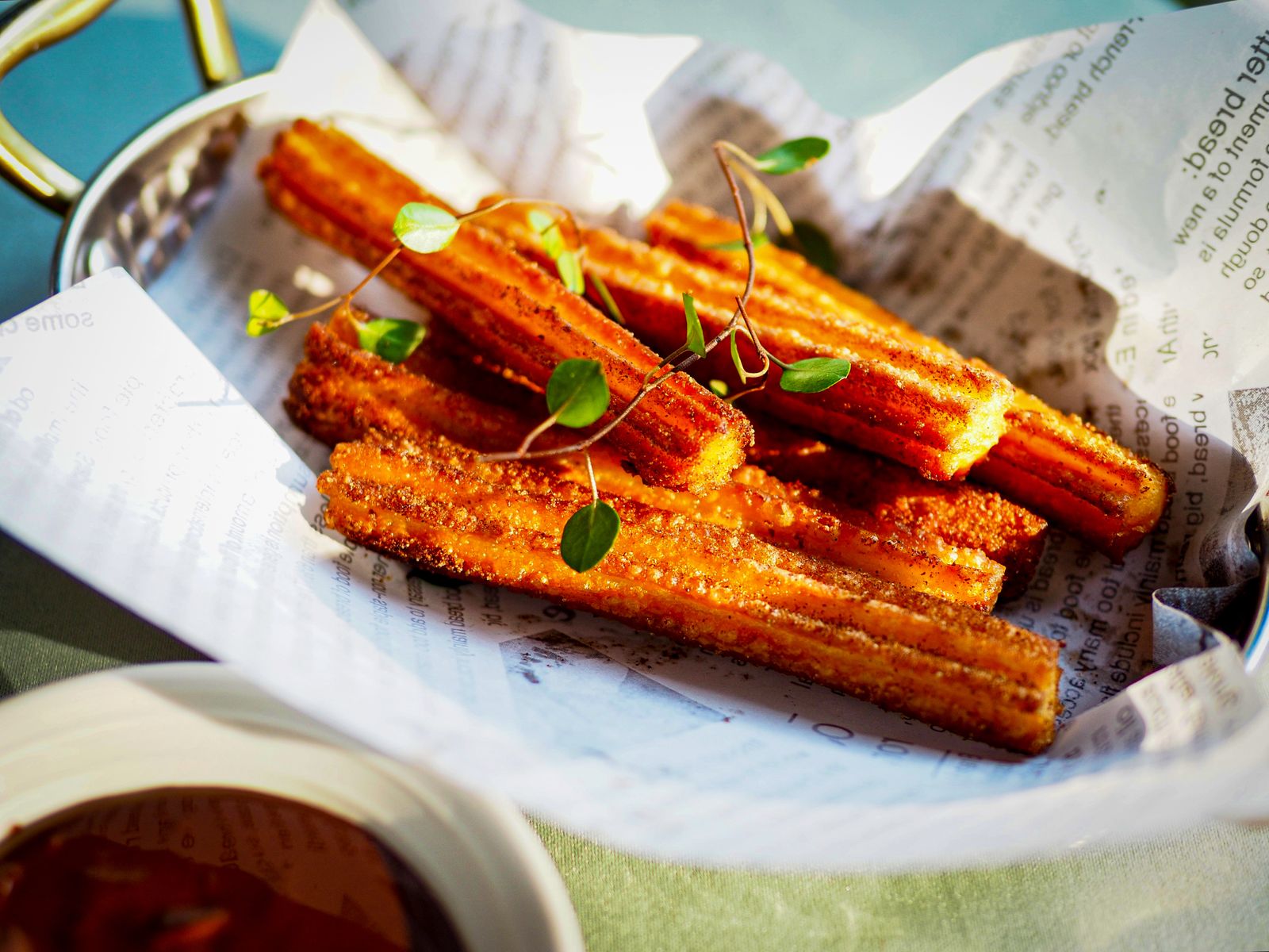 Golden churros dusted in cinnamon sugar with chocolate dipping sauce