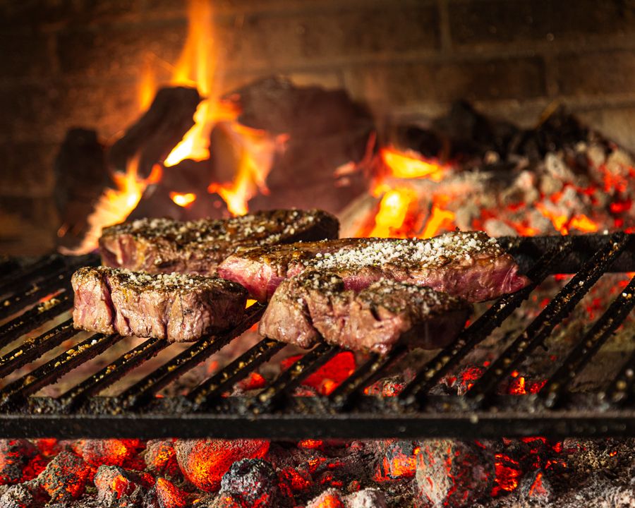Caramelized cuts searing over glowing coals