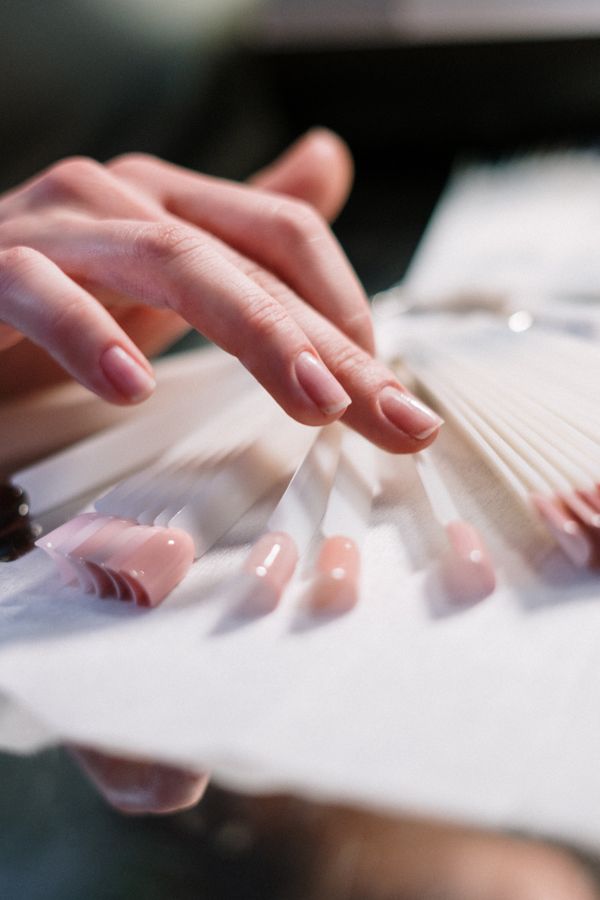 Fresh set of French-tip extensions being shaped