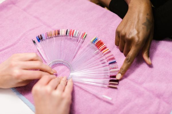 Choosing colors from a swatch fan at the nail desk