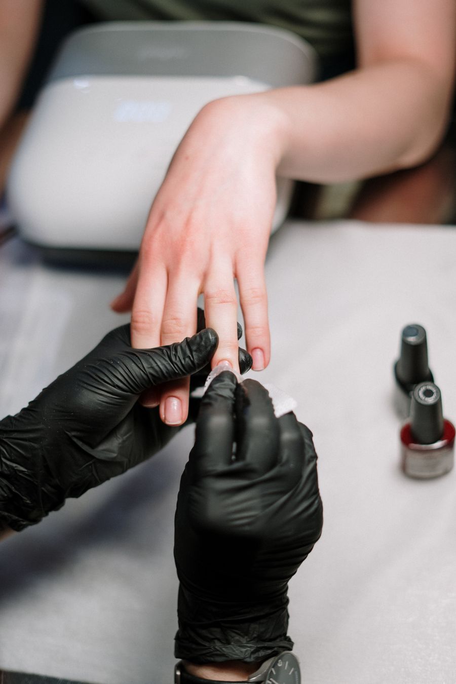 Nail artist shaping a custom acrylic set in the studio