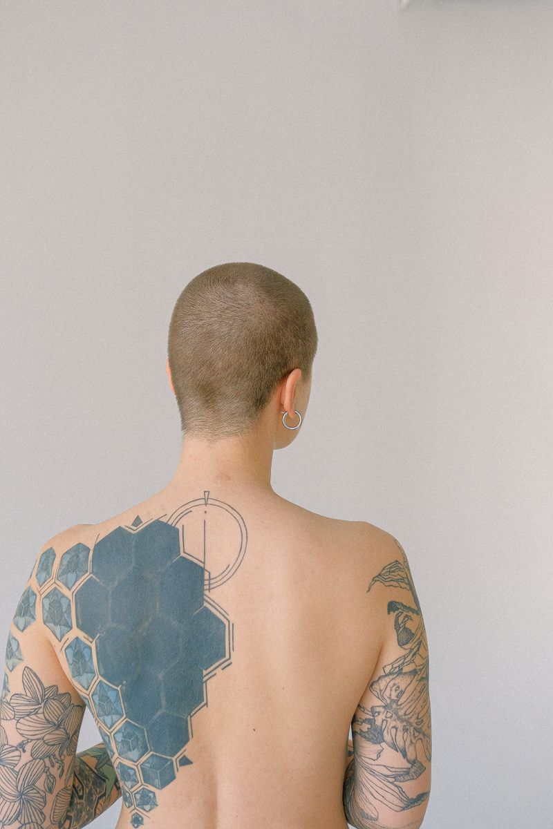 Large black tattoo across a person's back
